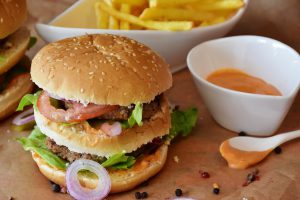 Beef burger with lettuce,ham,tomato,onion and sauces;nutrition tips for breastfeeding mothers
