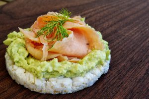 Rice cakes with bacon and broccoli puree and tender fried bacon on top.