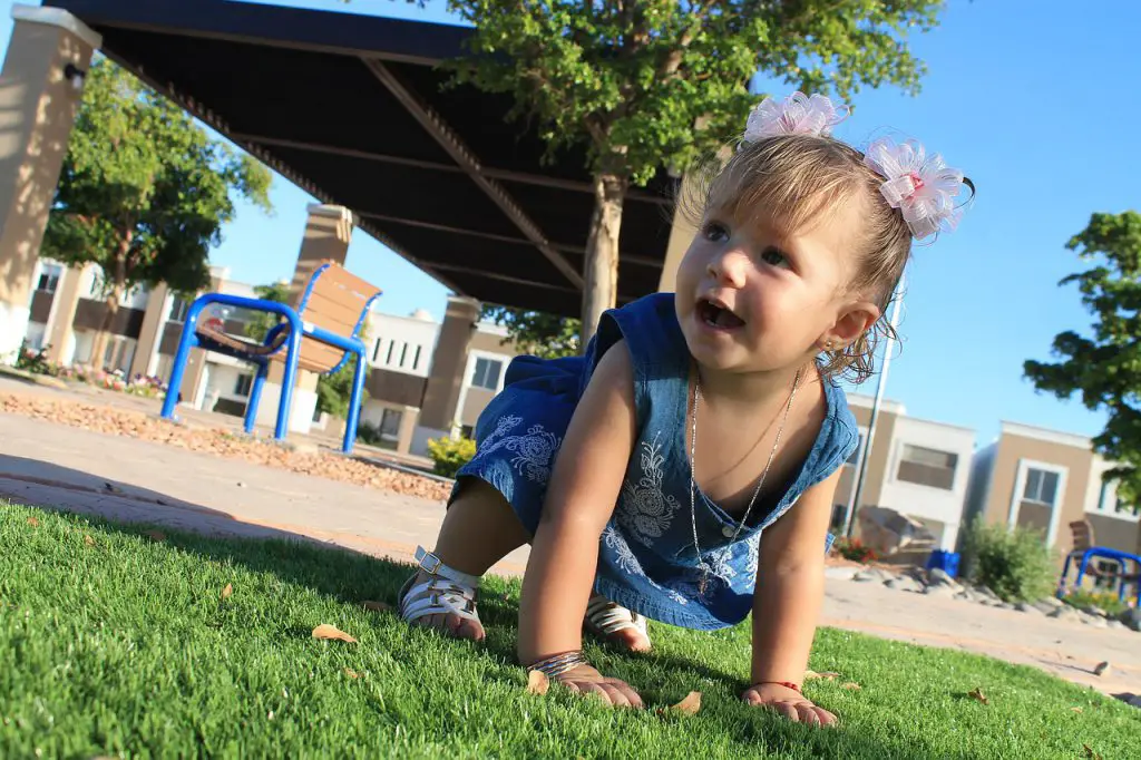 Baby crawling in the outdoors .