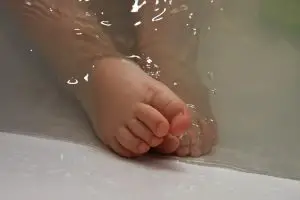 Newborn in bath water