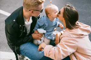 Father and Mother complimenting their baby in 15 month old development checklist