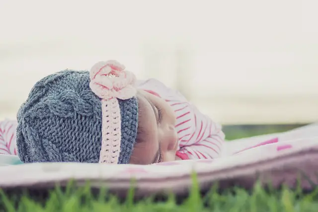 Baby lying down in Teething symptoms diarrhea.