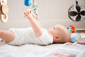 I month old baby activities; baby playing with toys