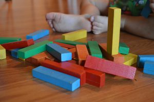 baby playing with blocks in infant activity ideas
