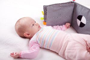 Baby looking at black and white board/ chart