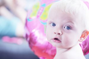 Baby with silky soft white textured hair.