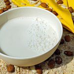 Bowl with almond milk and almonds on the ground in whole milk substitute. 