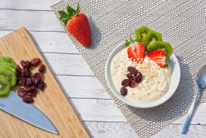 Homemade whole milk yogurt Raisins  ,strawberries ,yoghurt in a bowl 